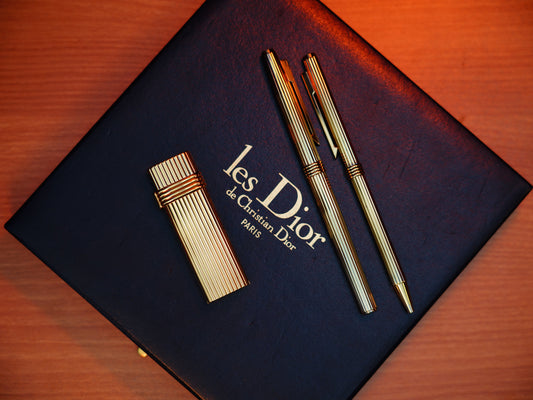 The Golden Age of Elegance: Dior’s Exquisite 1970s Heavy Gold Lighter & Vermill Writing Set